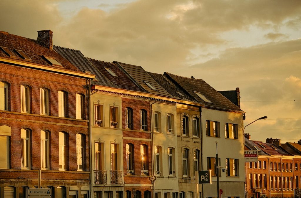 Elegant row of traditional townhouses bathed in sunset light, showcasing European architecture.